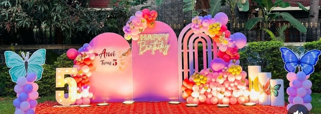 Outdoor butterfly theme birthday decoration with neon sign and balloon styling in Pune