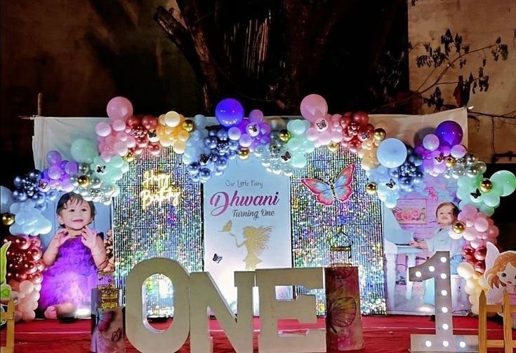 Shimmer wall fairy theme birthday decoration with colourful balloon garland at night