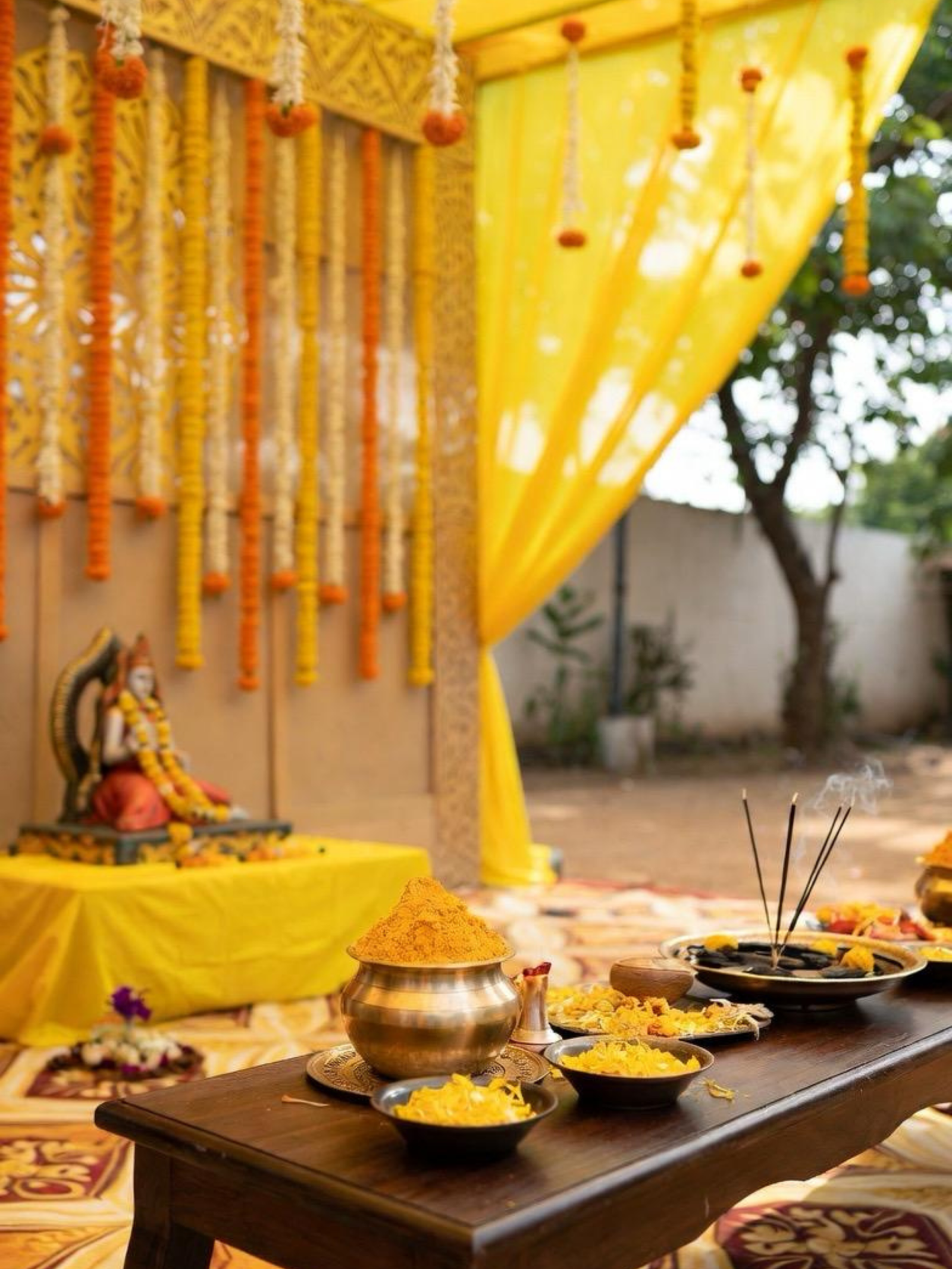 Religious pooja decoration setup with traditional backdrop by Magic Moment